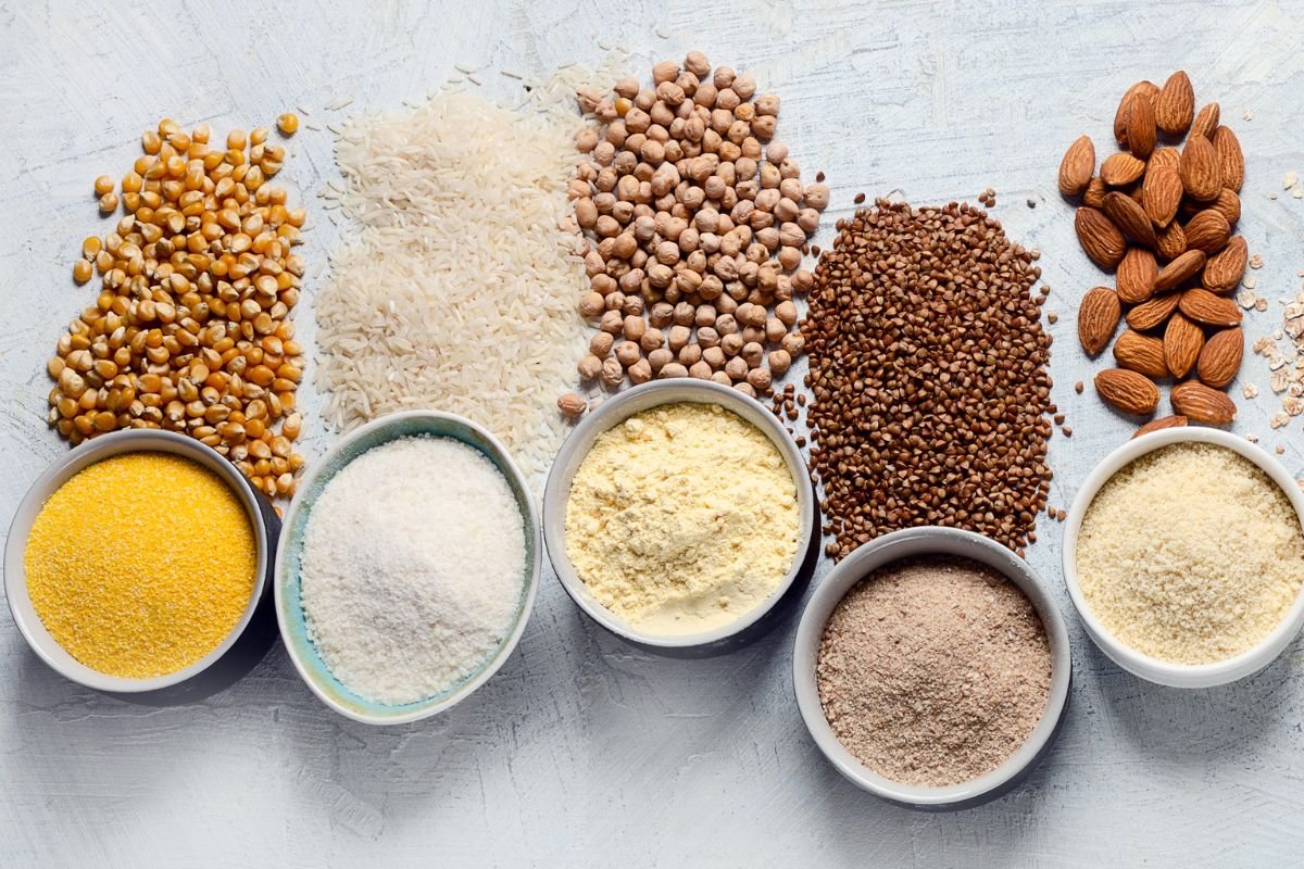 Various-gluten-free-flowers-chickpeas-rice-buckwheat-almond-corn-oatmeal-on-gray-background